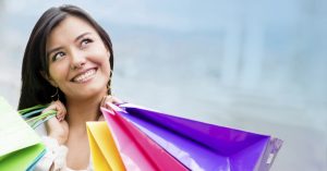 A lovely lady with colorful shopping bags who looks like she has had an amazing day spending other peoples money.