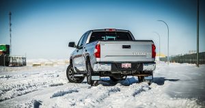 A silver Toyota Tundra on a snow covered road.