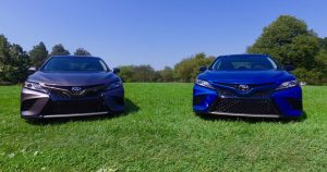 Two 2018 Toyota Camry's parked in a grassy field.