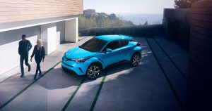 A blue 2019 Toyota C-HR XLE outside someones home.