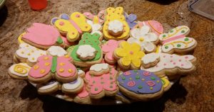 A colorful plate full of decorated Easter cookies.