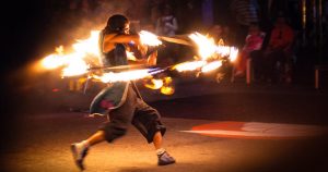 A fire dancer at a summer festival.