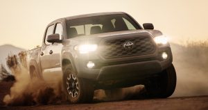 The 2020 Toyota Tacoma topping a sandy ridge.