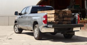 A silver 2019 Toyota Tundra loaded down with timbers.