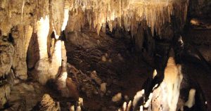 A view through stalactites and stalagmites into one of the chambers at the Cave of the Mounds.