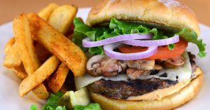 A juicy mushroom Swiss burger with thick cut fries.