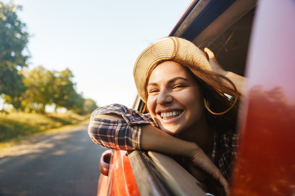 woman enjoying a summer road trip
