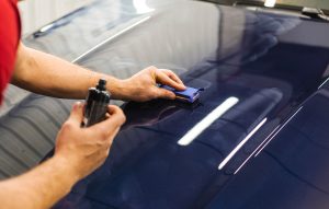 technician putting Exterior Paint Protective on a car