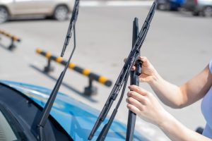 faceless woman replacing windshield wiper blades