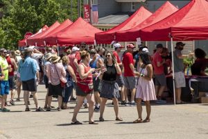 Beer Bacon & Cheese Festival midway with vendor tents and festival goers.