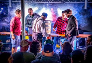 Tapping a wooden beer keg