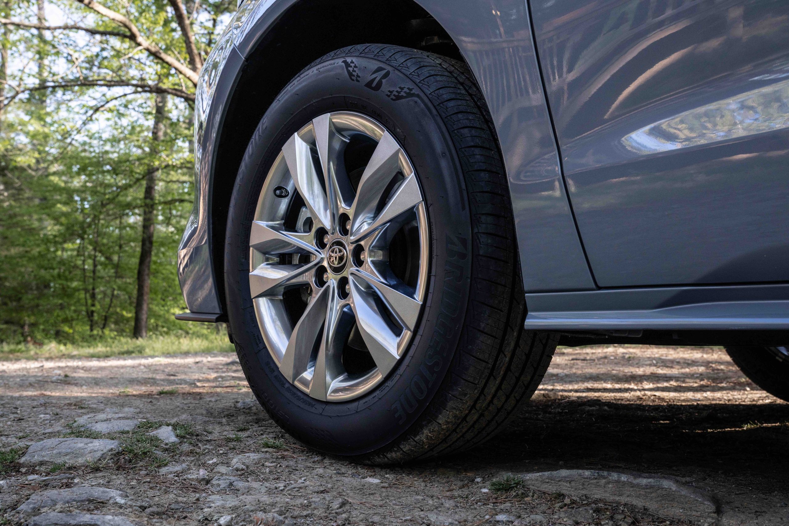 Close-up of a tire on the Toyota Sienna Woodland Edition on a rocky dirt trail