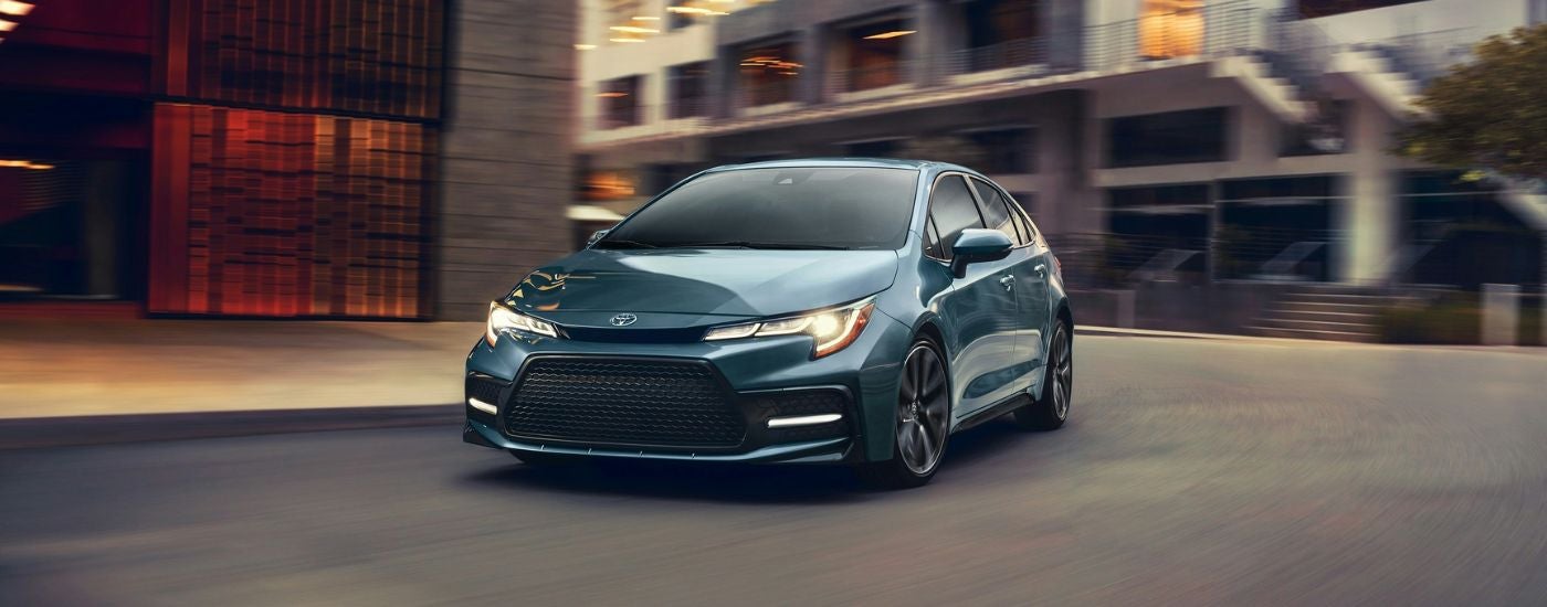 Blue 2020 Toyota Corolla driving through a city