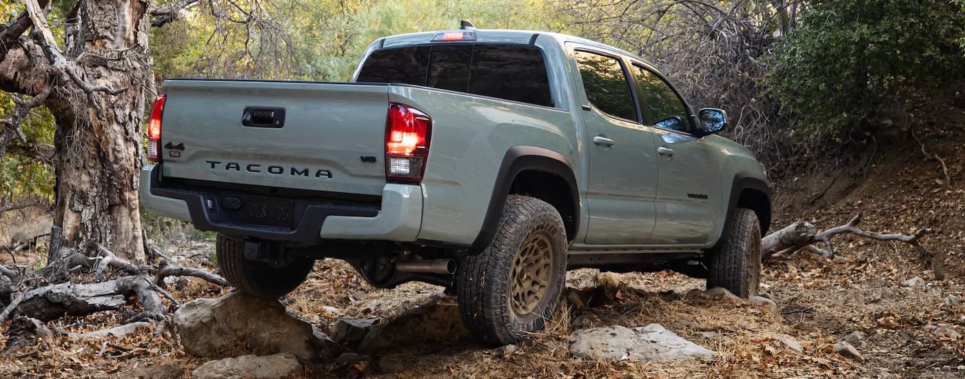 Grey 2022 Toyota Tacoma driving through a rock garden 
