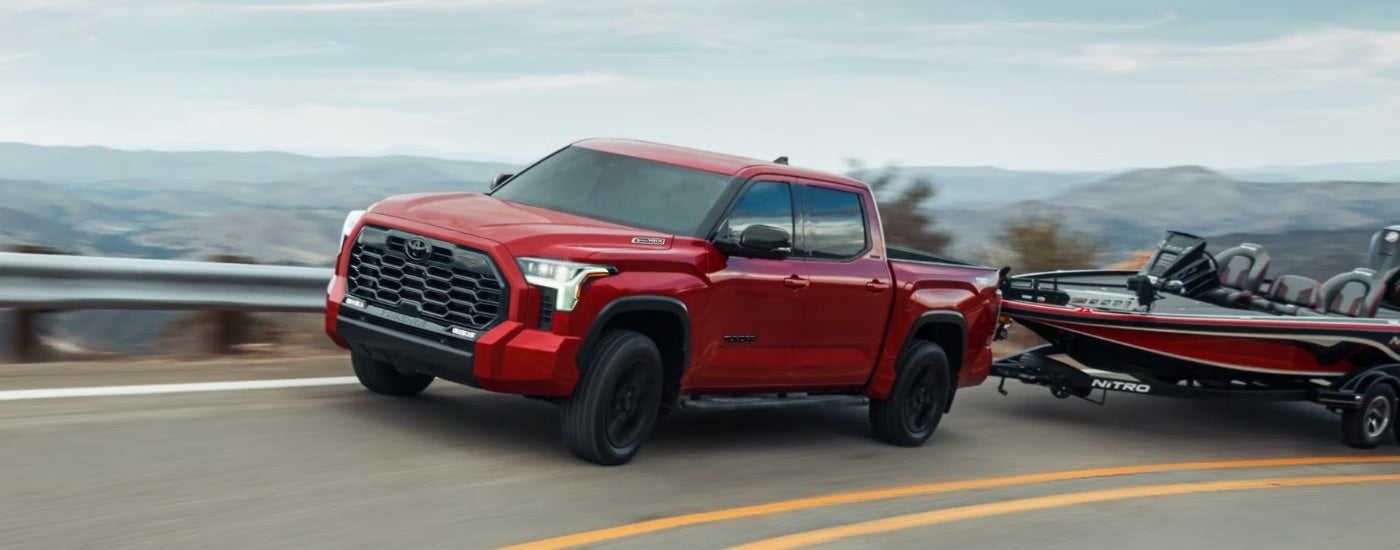 A red 2025 Toyota Tundra for sale from the side.