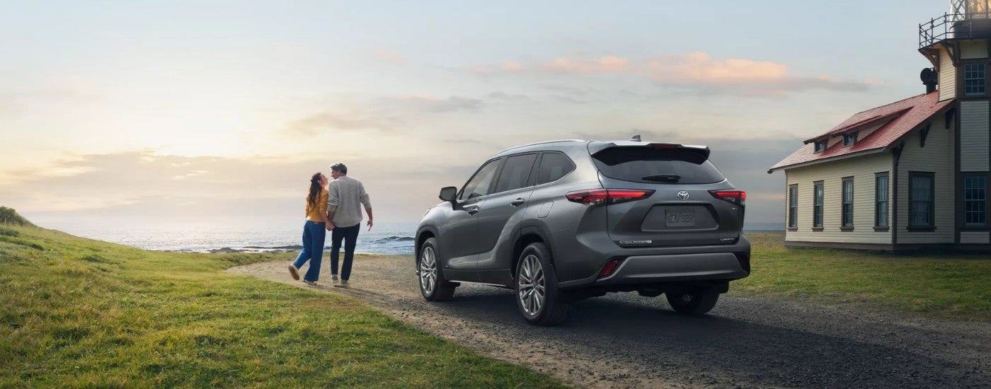 A grey 2025 Toyota Highlander from the rear at an angle.
