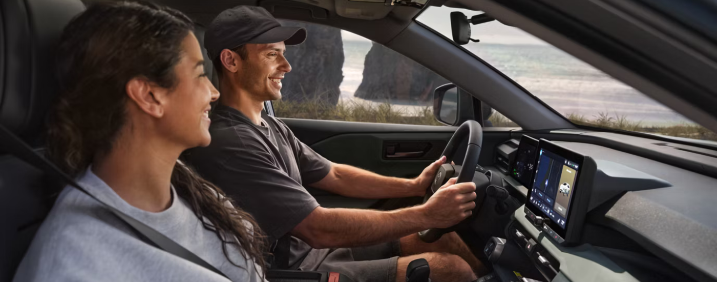 A couple driving in their 2026 Toyota RAV4