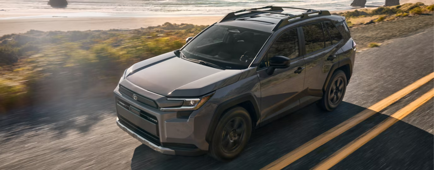 Grey 2026 Toyota RAV4 driving along a beach