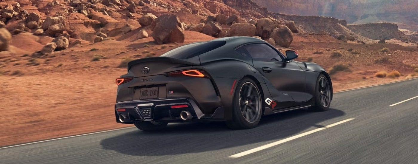 A black 2025 Toyota Supra from the rear after leaving a Toyota dealer near Verona.
