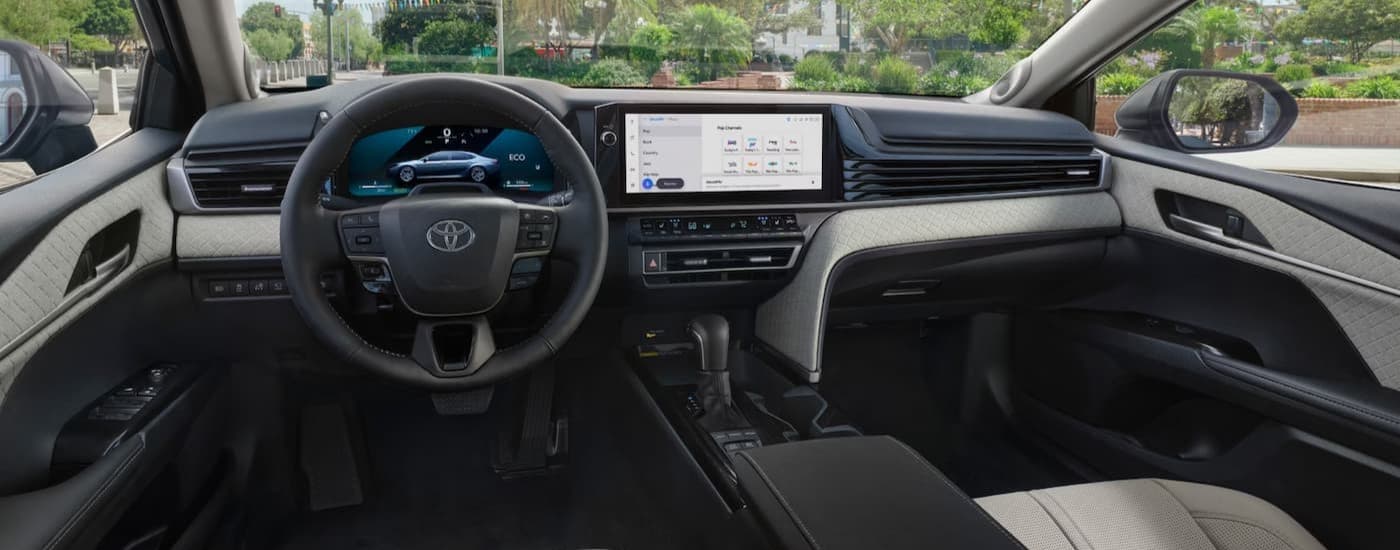 The black and gray interior and dash in a 2025 Toyota Camry for sale.