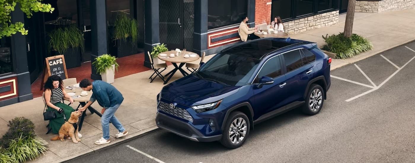 A blue 2025 Toyota RAV4 parked in a city after visiting a Toyota dealer near Watertown.